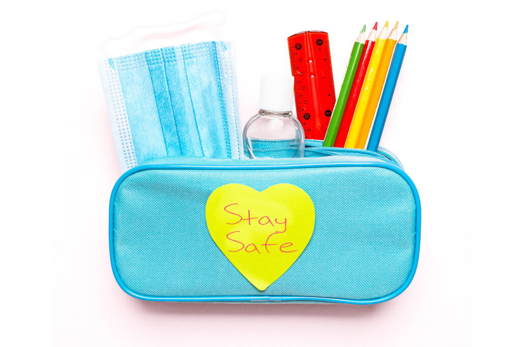 light blue pencil case containing mask and supplies with 'stay safe' heart shaped post it on front