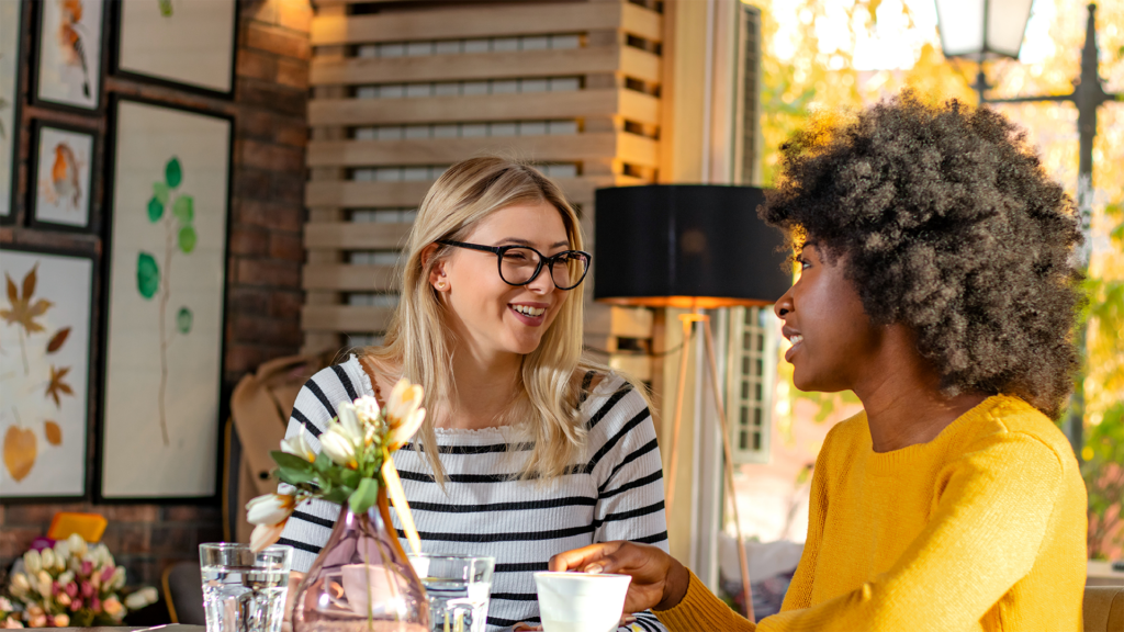 Two women having coffee and chatting