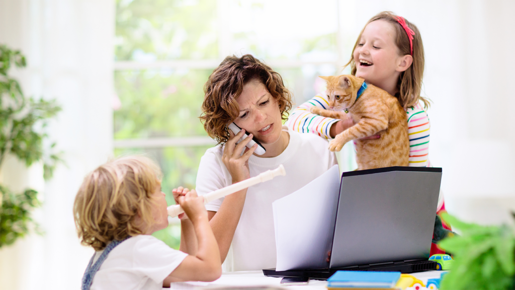 Busy mom trying to work while two busy kids distract her