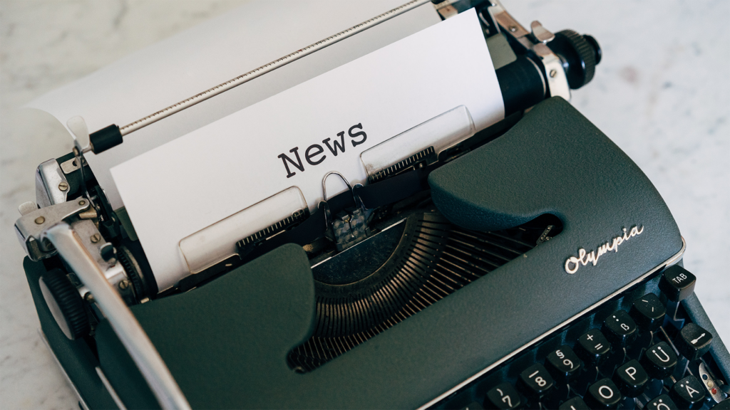 Manual typewriter with 'News' typed on paper