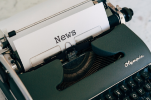 Manual typewriter with 'News' typed on paper