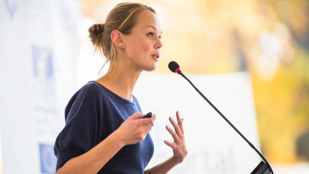 Woman standing at a microphone