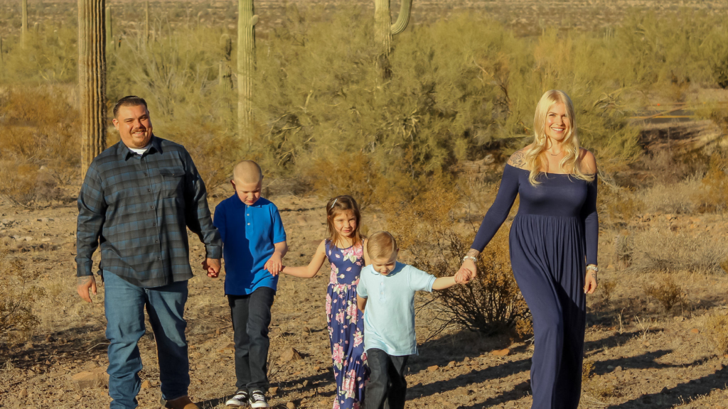 family with three children outside in the desert