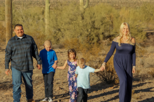 family with three children outside in the desert