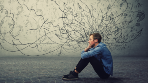 teen sitting on the ground surrounded by illustrations of questions marks and squiggly lines