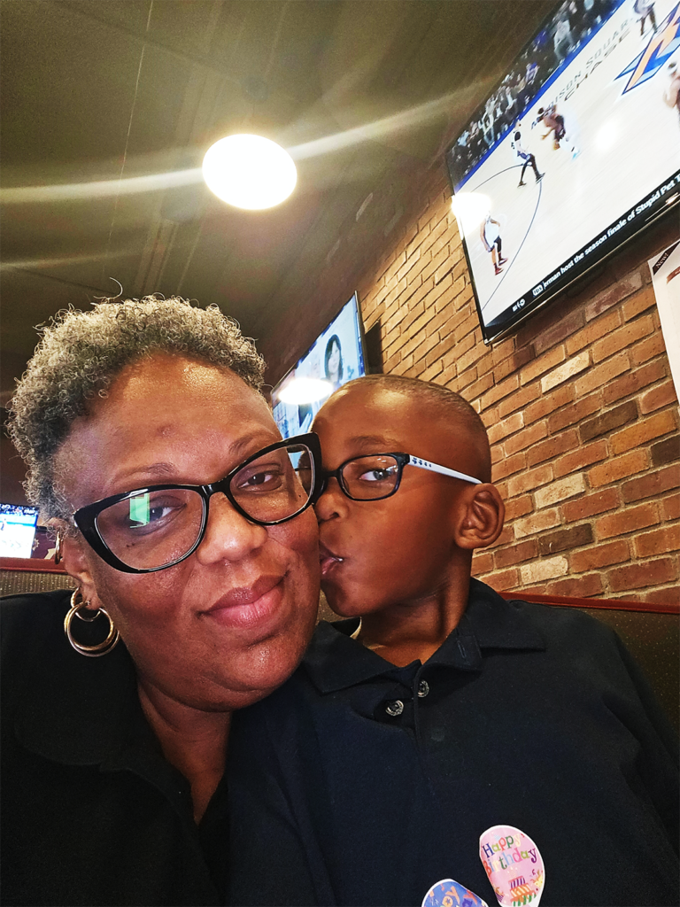 young boy kissing his mom on the cheek